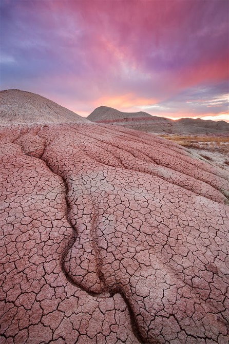 12Sunset-over-cracked-mud-formation,-Badlands-National-Park,-South-Dakota,-USAIanPlant